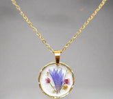 Real pressed flower round pendant necklace in clear resin. Lightweight, nature-inspired, and handcrafted for a unique botanical jewelry statement.