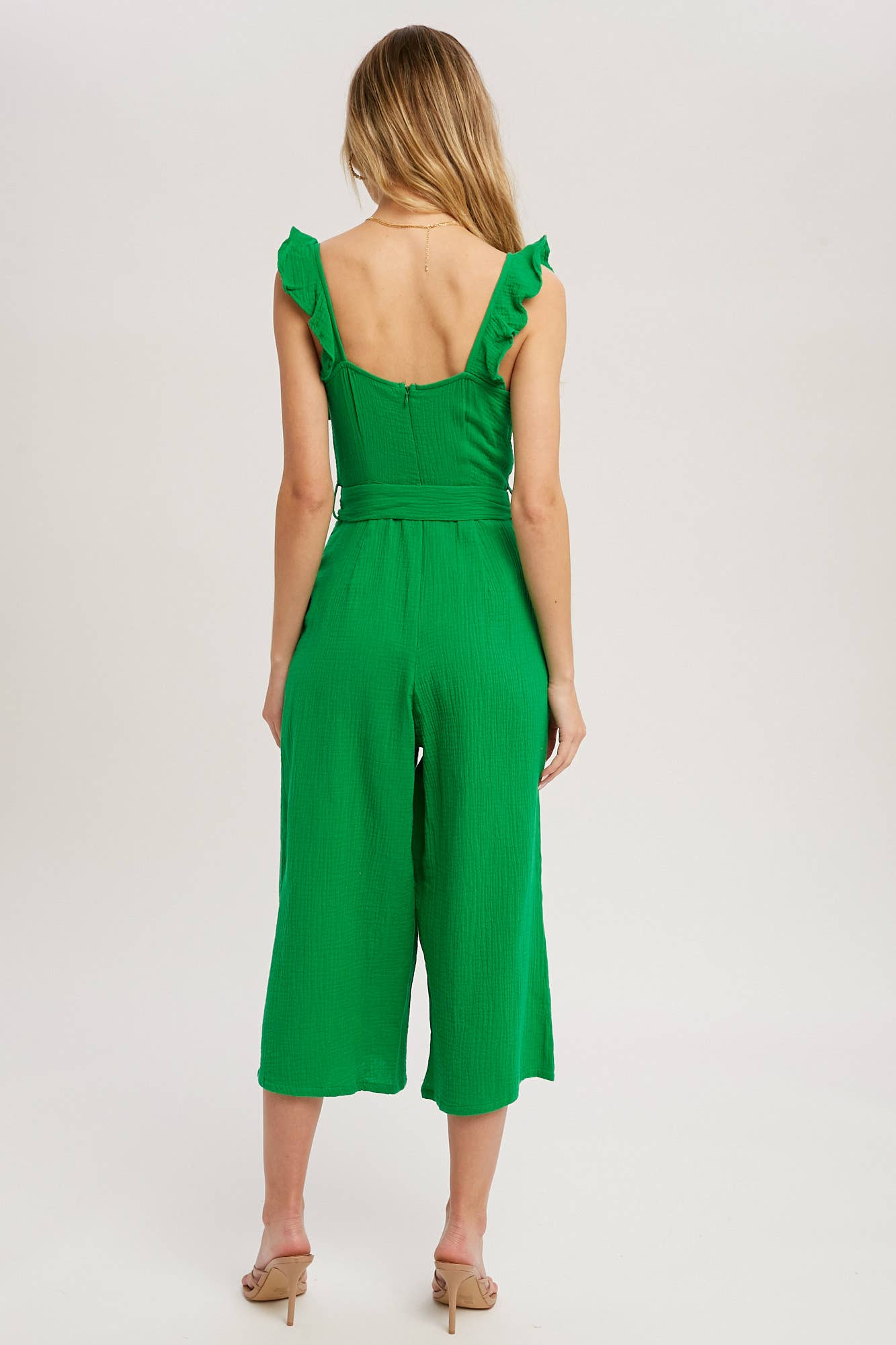 Chic textured cotton jumpsuit with frill trim, wide-leg fit, side pockets, self-tie waist, and back zipper. A relaxed, flattering one-piece for any season.