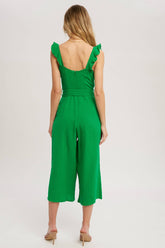 Chic textured cotton jumpsuit with frill trim, wide-leg fit, side pockets, self-tie waist, and back zipper. A relaxed, flattering one-piece for any season.
