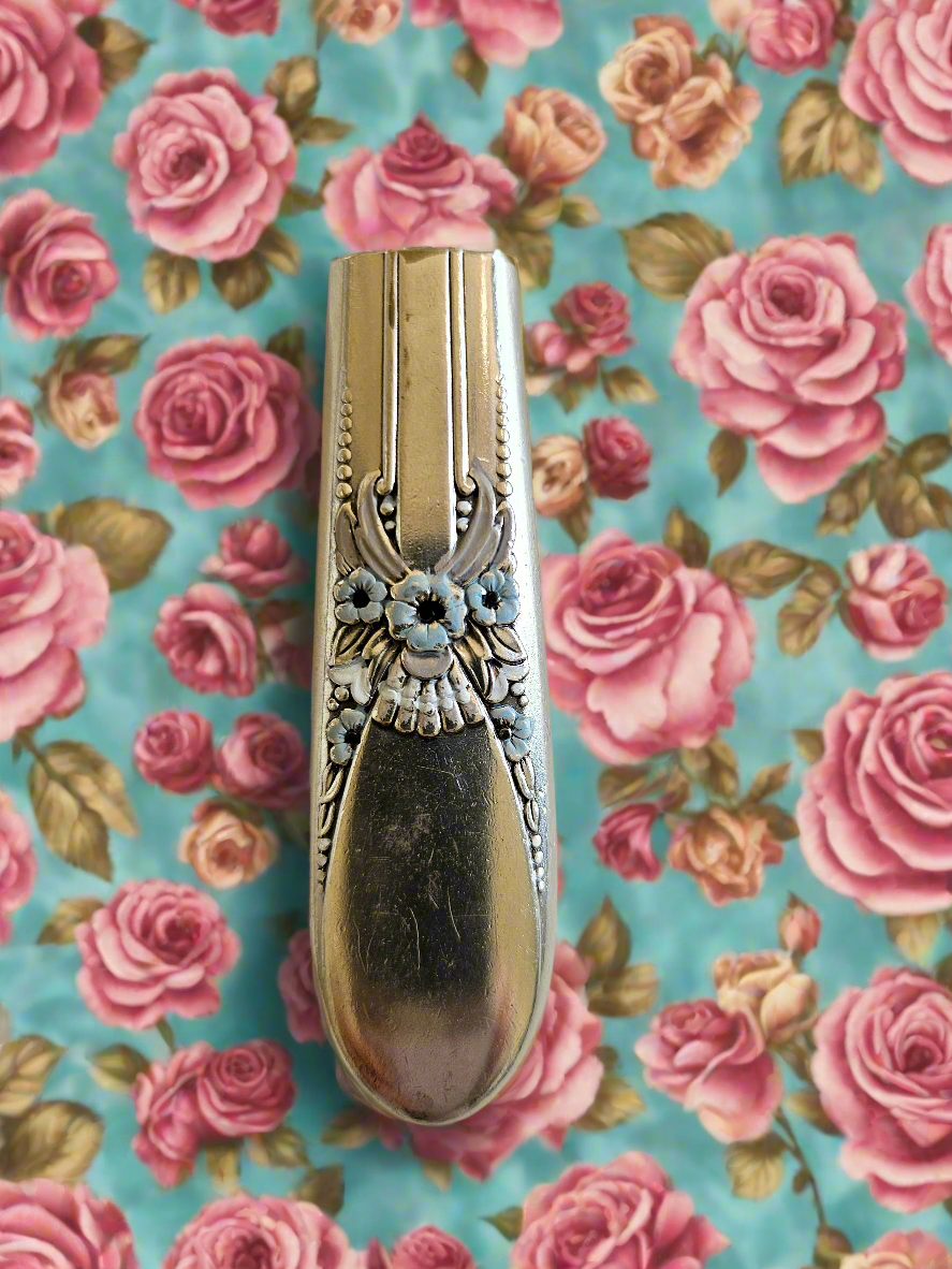 Whimsical bud vases crafted from vintage silverware with magnetic backs—perfect for single blooms and small clippings. Each one is a one-of-a-kind treasure.