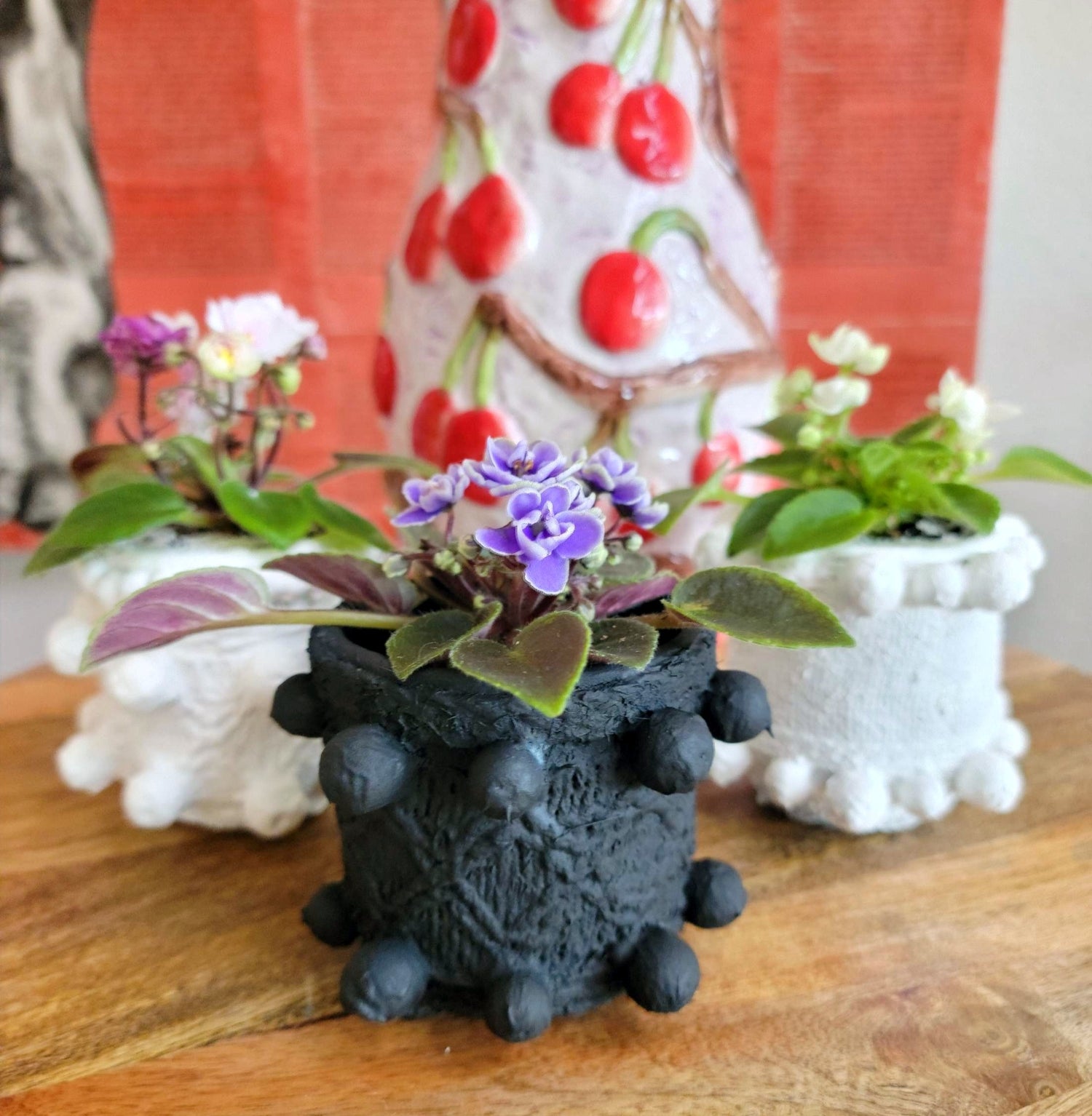 Elevate your home decor with this one-of-a-kind upcycled, handcrafted Small Planter. Made from reclaimed materials, each piece features a unique textured finish and comes in 4 finishes: Black, White, Sand, and Light Pink. Available with or without a plant, it&