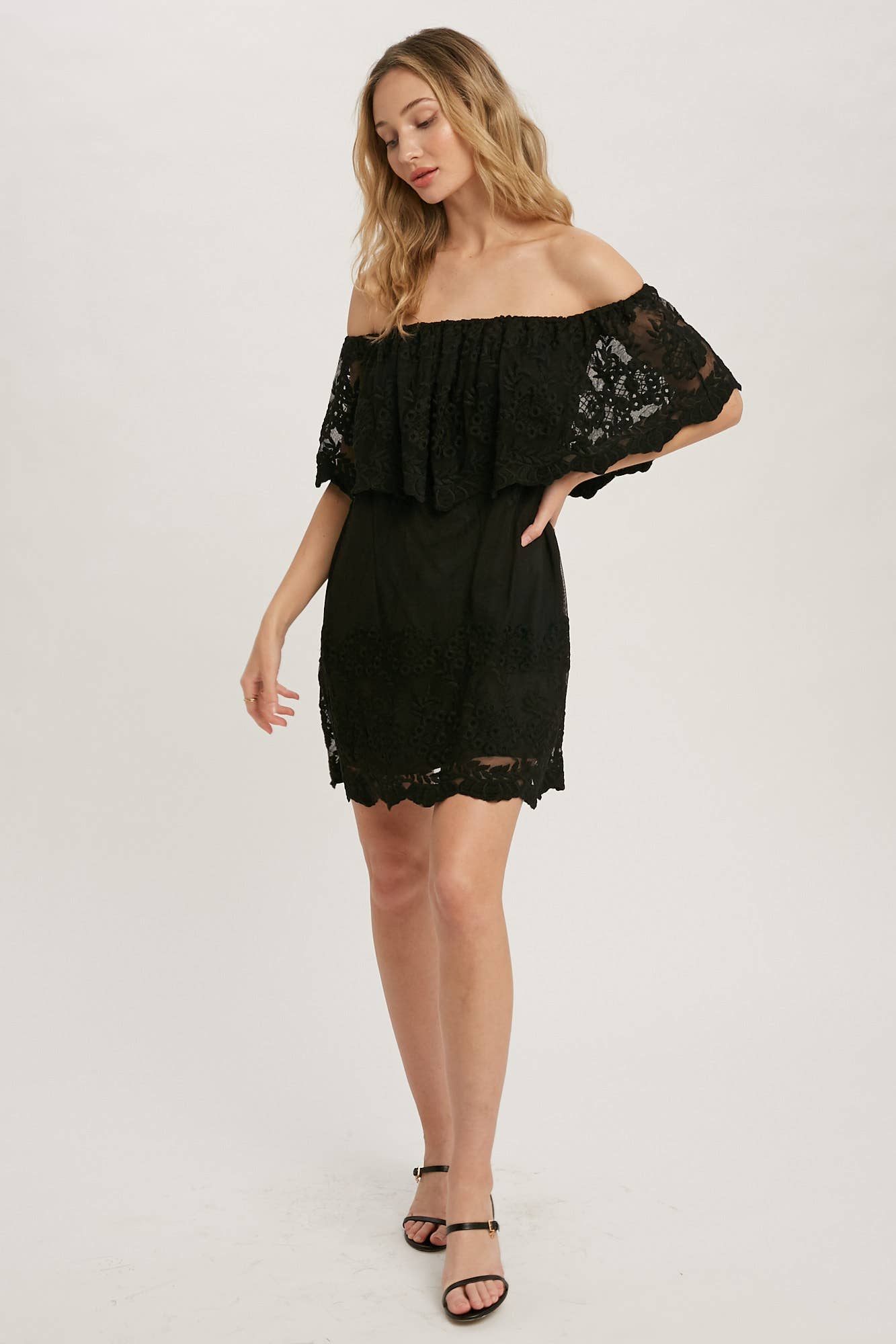 Off-the-shoulder floral lace mini dress with elastic neckline and swingy flounce silhouette. Romantic woven lace, scalloped hem, feminine fit.