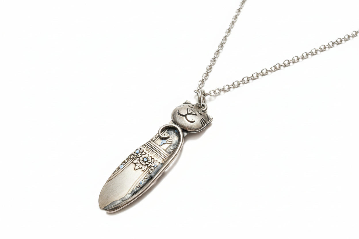 Handmade silver cat pendant necklaces from vintage silverware. Elegant, whimsical, and adjustable on a satin cord. Sustainably crafted and one-of-a-kind.