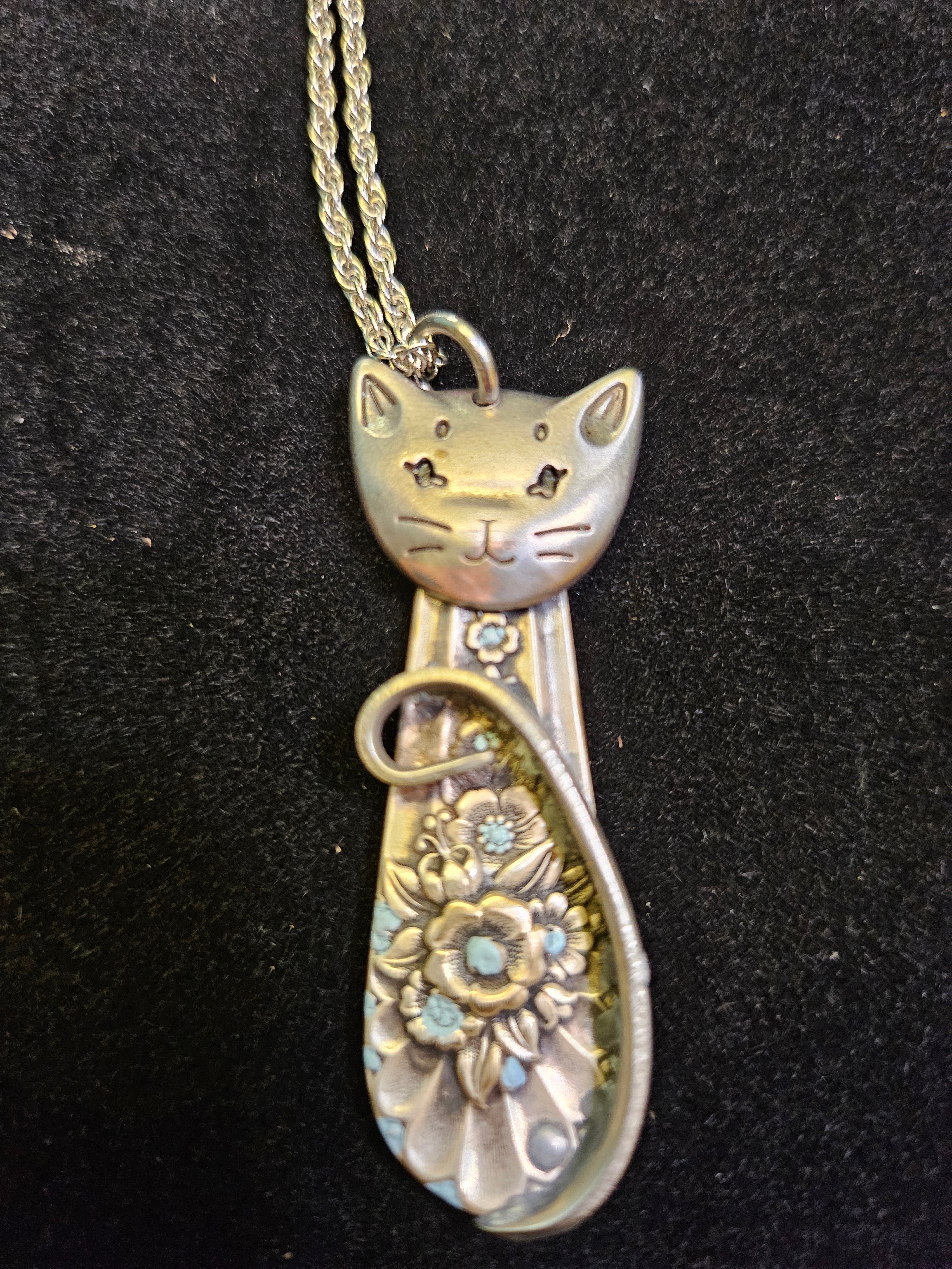 Handmade silver sassy cat pendant necklaces from vintage silverware. Elegant, whimsical, and adjustable on a satin cord. Sustainably crafted and one-of-a-kind.