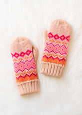Blush, pink, orange & light pink patterned knit mittens with cozy fleece lining. Made from 100% acrylic for warmth, comfort, and playful winter style.