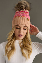 Blush, pink & orange patterned knit hat with natural faux fur pom. Fleece lined for extra warmth & pairs perfectly with matching mittens. 100% acrylic.