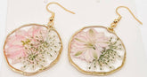 Blushing Bloom earrings feature real pink delphinium and Queen Anne’s Lace in clear resin with copper frames—lightweight, romantic, and naturally one-of-a-kind.