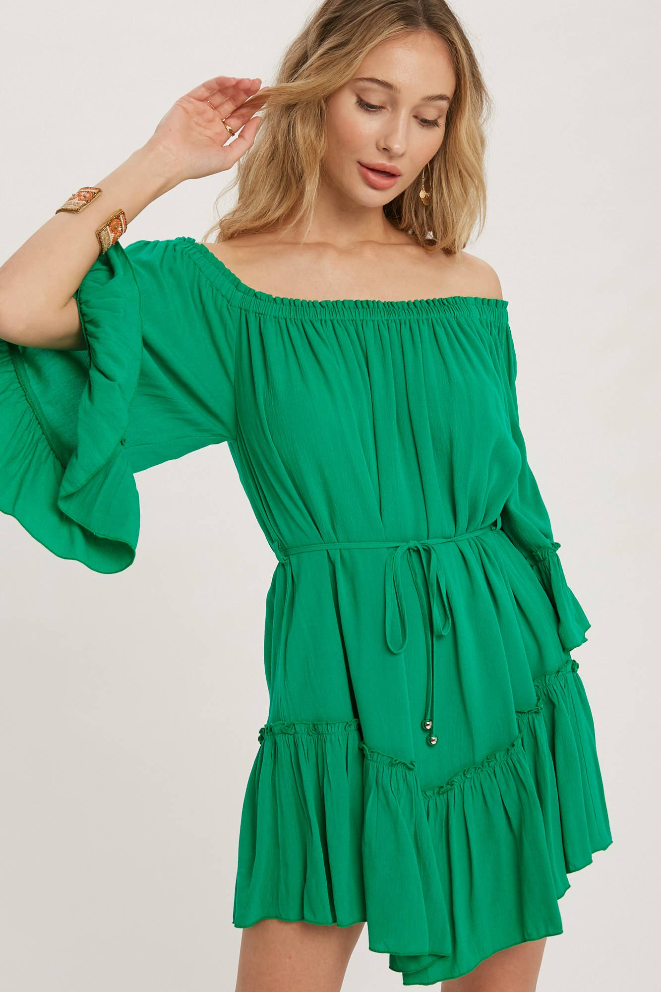Romantic off-shoulder dress with ruffled sleeves, frilled hem, and a swingy silhouette. Adjustable belt adds shape to this breezy, flounce favorite.