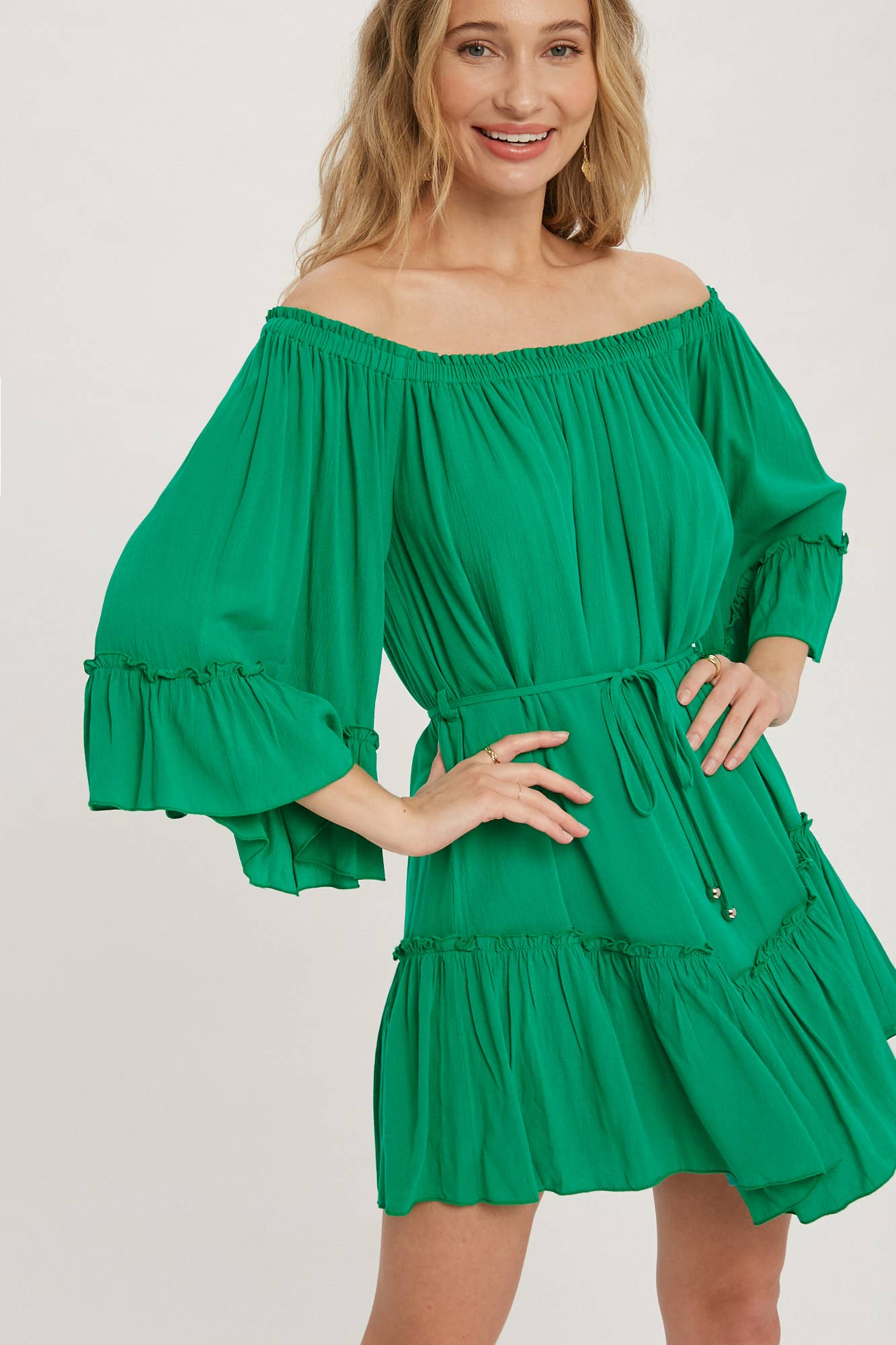Romantic off-shoulder dress with ruffled sleeves, frilled hem, and a swingy silhouette. Adjustable belt adds shape to this breezy, flounce favorite.