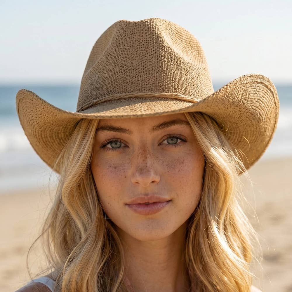 Braided cord band cowboy hat featuring woven paper straw texture and soft curved brim. Lightweight boho western style perfect for beach days, festivals, and summer outfits.