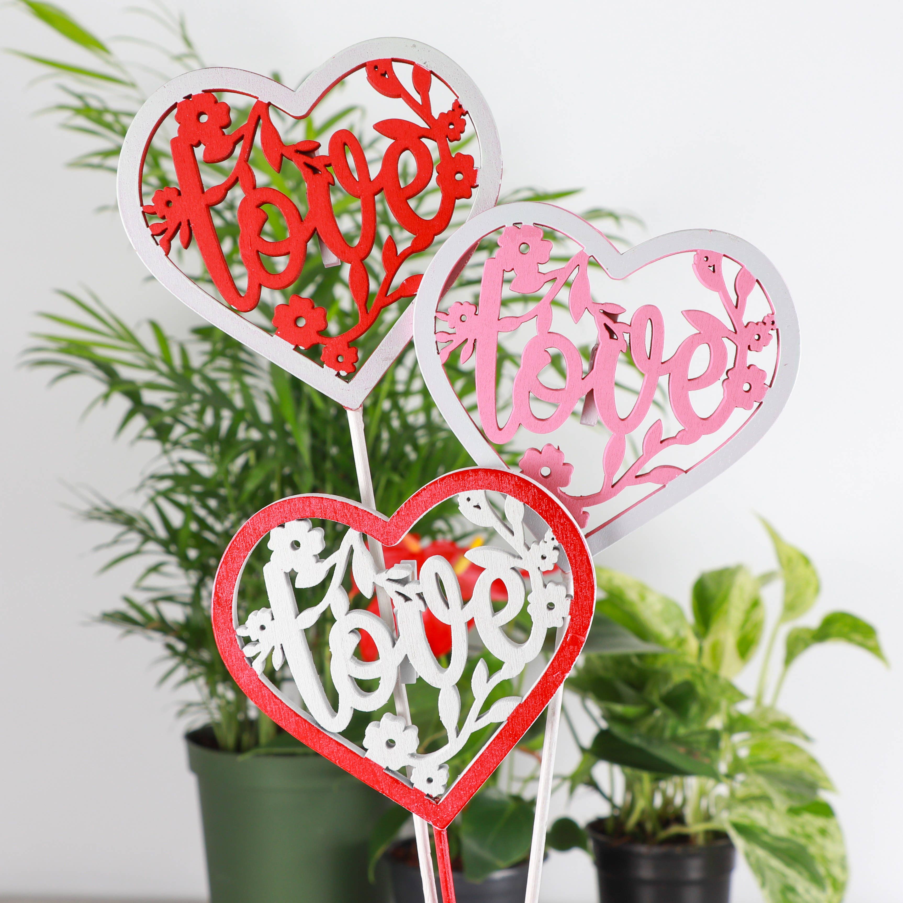 Wooden heart plant picks with built-in clip for cards or notes. Perfect finishing touch for houseplant gifts. Trim-to-fit 18" stake. No plants