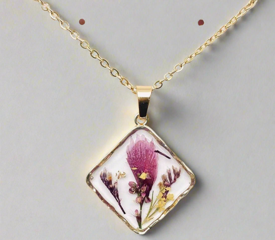 Handcrafted square pendant necklace with real pressed dried flowers in clear resin. Unique botanical jewelry with stainless steel chain and copper frame.