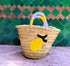 Cheerful straw tote with crocheted lemon patch and colorful handles. Lightweight, eco-friendly, and perfect for markets, beach days, or sunny adventures.