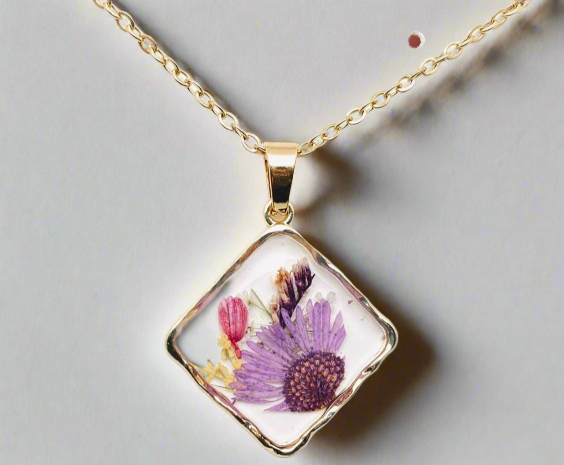 Handcrafted square pendant necklace with real pressed dried flowers in clear resin. Unique botanical jewelry with stainless steel chain and copper frame.