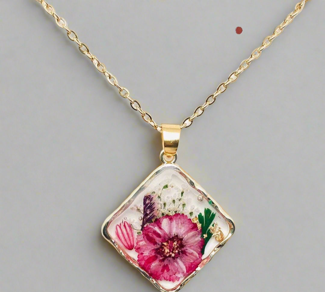 Handcrafted square pendant necklace with real pressed dried flowers in clear resin. Unique botanical jewelry with stainless steel chain and copper frame.