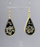 Dark Botanica earrings showcase real Queen Anne’s Lace in black resin teardrop earrings with gold-plated frames—bold, elegant earrings that are naturally one-of-a-kind.