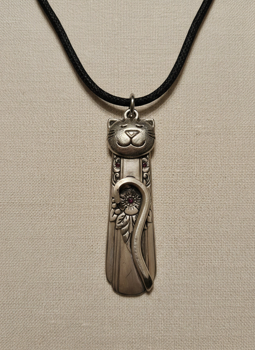 Handmade silver cat pendant necklaces from vintage silverware. Elegant, whimsical, and adjustable on a satin cord. Sustainably crafted and one-of-a-kind.