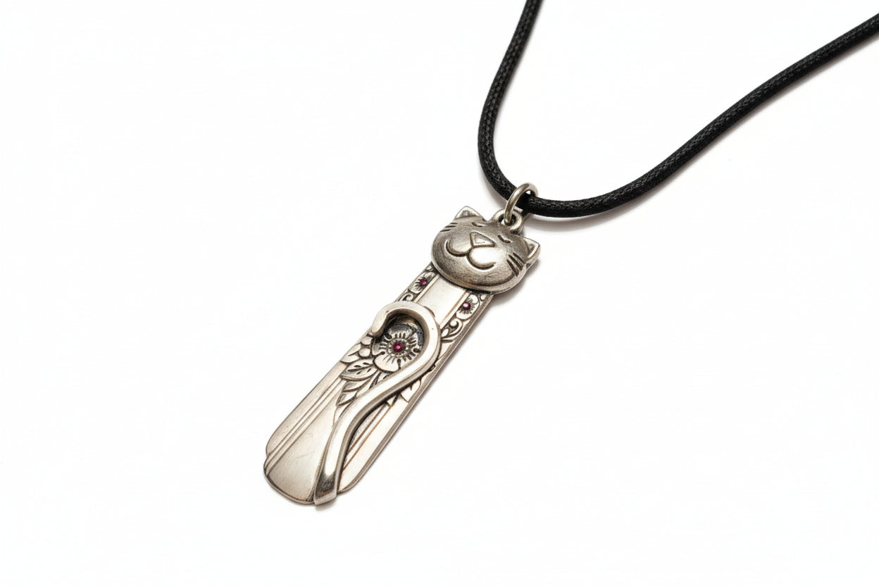 Handmade silver cat pendant necklaces from vintage silverware. Elegant, whimsical, and adjustable on a satin cord. Sustainably crafted and one-of-a-kind.