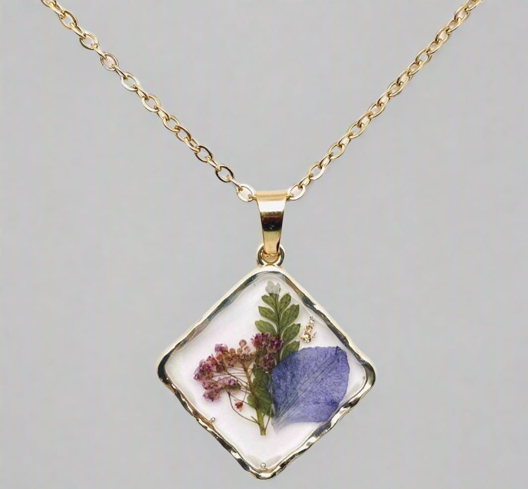 Handcrafted square pendant necklace with real pressed dried flowers in clear resin. Unique botanical jewelry with stainless steel chain and copper frame.