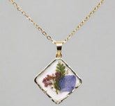 Handcrafted square pendant necklace with real pressed dried flowers in clear resin. Unique botanical jewelry with stainless steel chain and copper frame.