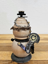The Handmade Wood Block Steampunk Robot is a unique, decorative figurine crafted from wood with an aged, rustic look. Each robot is one-of-a-kind for display only. Includes a heart-shaped balloon. Available in various sizes, it&