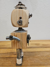 The Handmade Wood Block Steampunk Robot is a unique, decorative figurine crafted from wood with an aged, rustic look. Each robot is one-of-a-kind for display only. Includes a heart-shaped balloon. Available in various sizes, it&