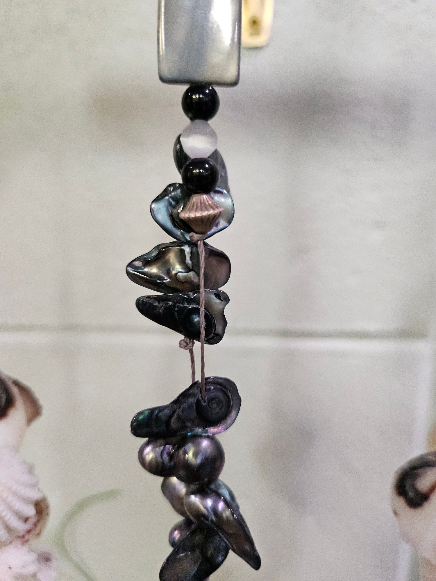 Add coastal charm to your space with the Shell & Bead Bohemian Suncatcher. Handcrafted with natural shells, semi-precious stones, and beads, it captures sunlight to create a stunning display of light and texture, perfect for windows, gardens, or as a unique, nature-inspired gift.