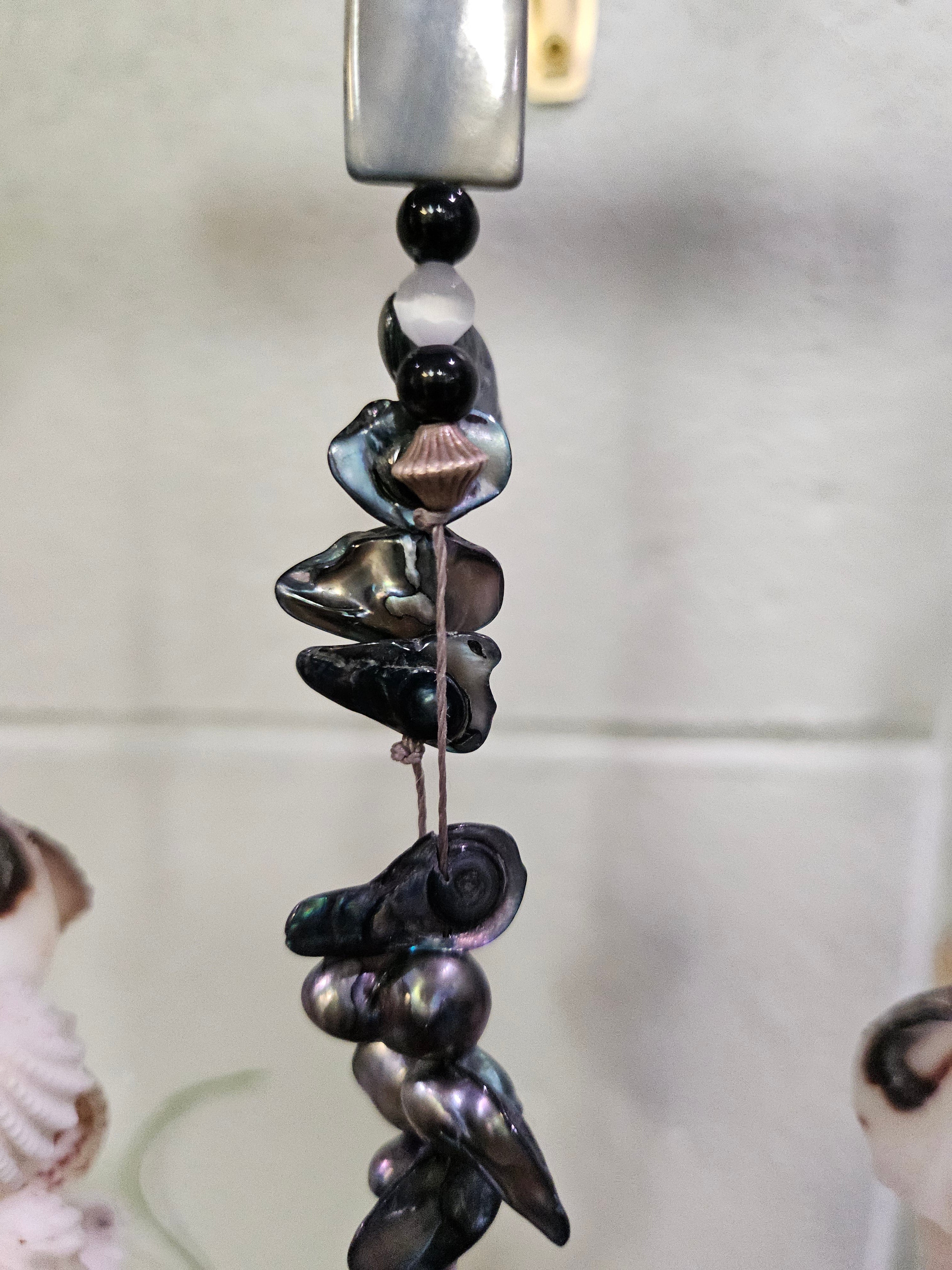 Add coastal charm to your space with the Shell & Bead Bohemian Suncatcher. Handcrafted with natural shells, semi-precious stones, and beads, it captures sunlight to create a stunning display of light and texture, perfect for windows, gardens, or as a unique, nature-inspired gift.