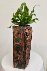 This Hand-Carved & Painted Wood Spirit Planter in solid walnut features intricate details and black-painted accents. 100% handmade, each piece is unique and perfect for home decor or garden. The natural walnut grain and artisanal craftsmanship add rustic charm, making it a standout decorative piece for any space.