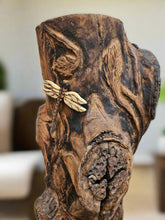 The Hand-Carved Dragonfly Outdoor Planter and Solar Light Wood Spirit in Solid Walnut (30" x 10"). 100% handmade, each piece is unique and perfect for home decor. The natural walnut grain and artisanal craftsmanship add rustic charm, making it a standout decorative piece for any space.