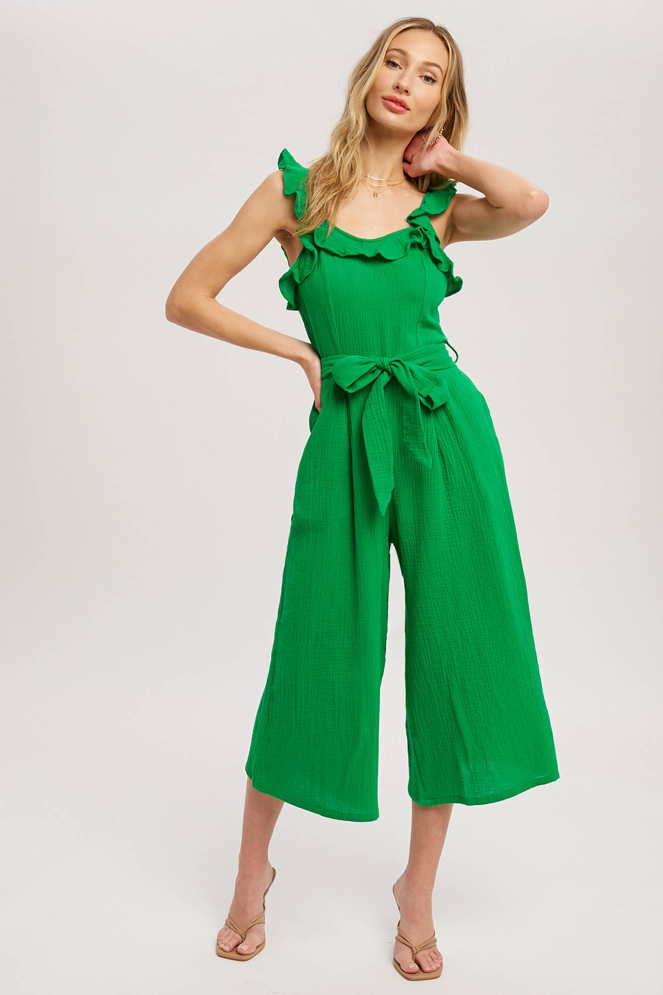 Chic textured cotton jumpsuit with frill trim, wide-leg fit, side pockets, self-tie waist, and back zipper. A relaxed, flattering one-piece for any season.