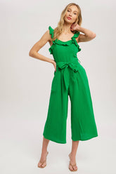 Chic textured cotton jumpsuit with frill trim, wide-leg fit, side pockets, self-tie waist, and back zipper. A relaxed, flattering one-piece for any season.