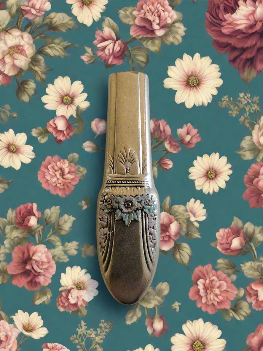 Whimsical bud vases crafted from vintage silverware with magnetic backs—perfect for single blooms and small clippings. Each one is a one-of-a-kind treasure.