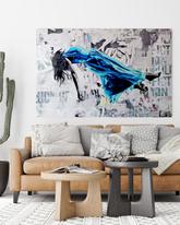Float 5 is a 36"x48" mixed media artwork blending surrealism and street art. Featuring a figure floating mid-air in a blue gown against a gritty urban backdrop, it explores themes of escape and transcendence. Perfect for modern spaces, this visually striking piece adds depth and intrigue, pairing beautifully with a Palm.