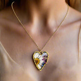 Heart-shaped necklace with real pressed flowers in resin, set in 18K gold-plated copper. Unique, handmade botanical jewelry with stainless steel chain.
