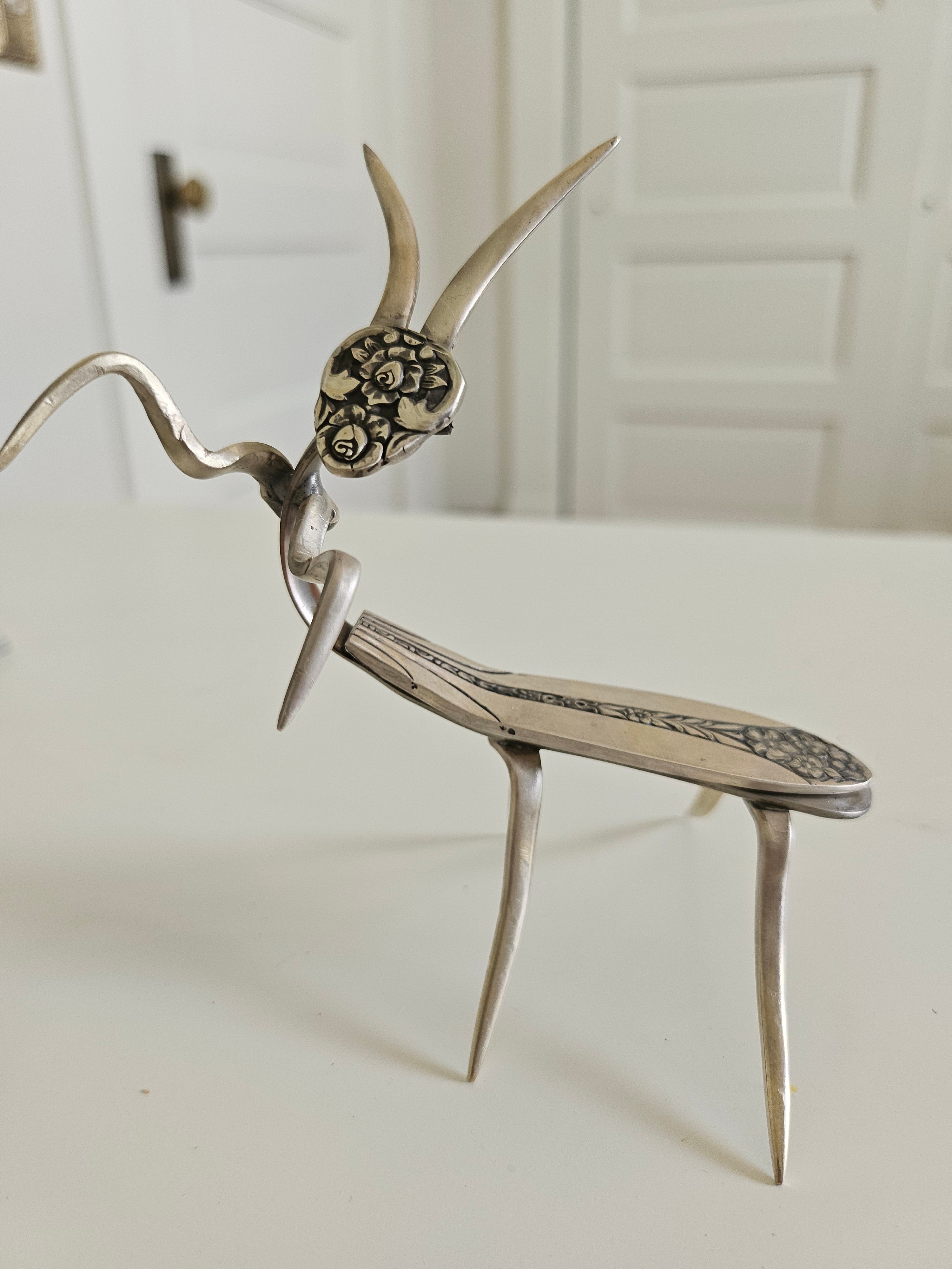 Handcrafted 5" x 4" praying mantis sculpture made from vintage silverware. Unique, whimsical art with gemstone accents and aged patina for mindful décor.