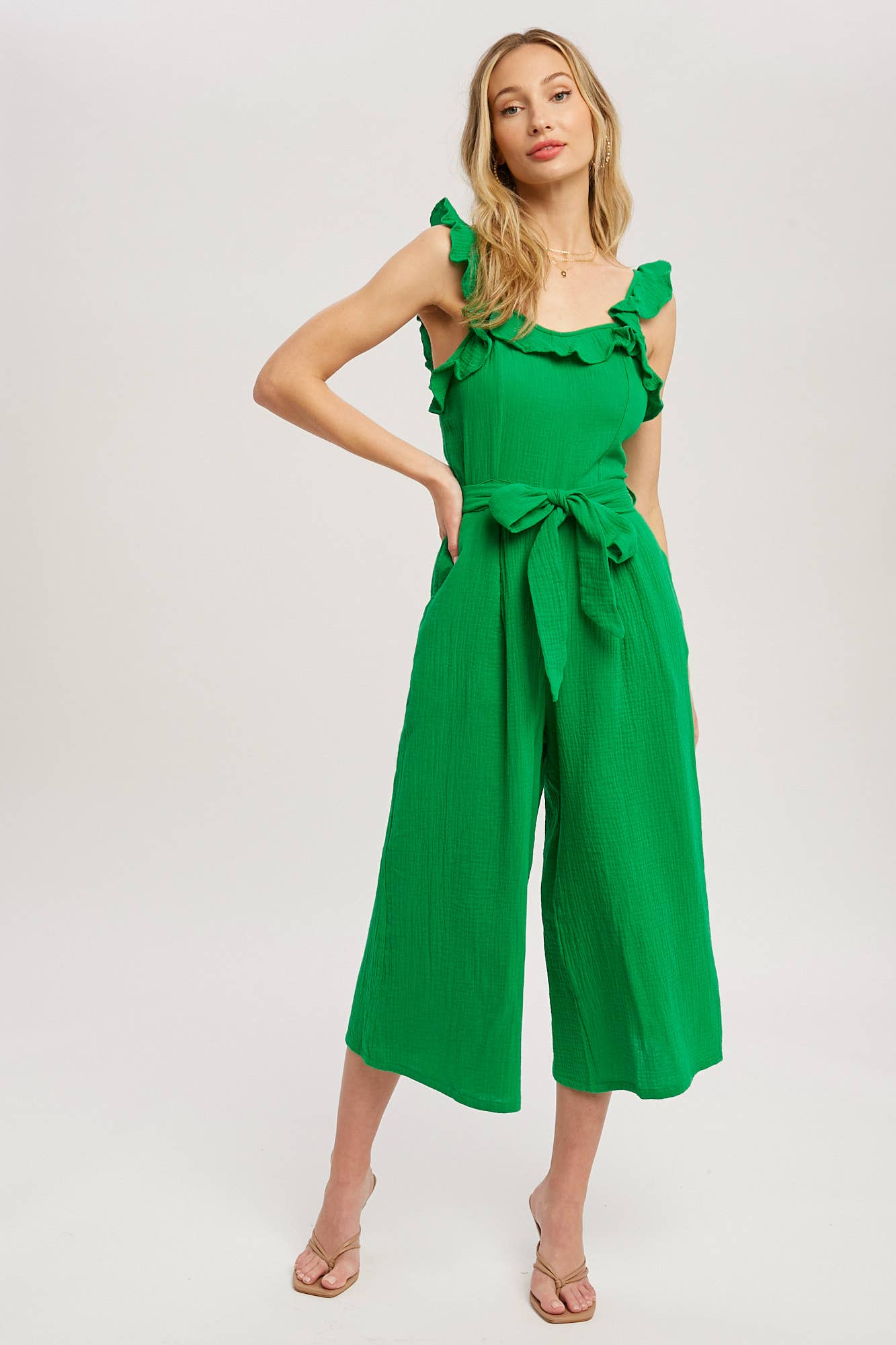 Chic textured cotton jumpsuit with frill trim, wide-leg fit, side pockets, self-tie waist, and back zipper. A relaxed, flattering one-piece for any season.