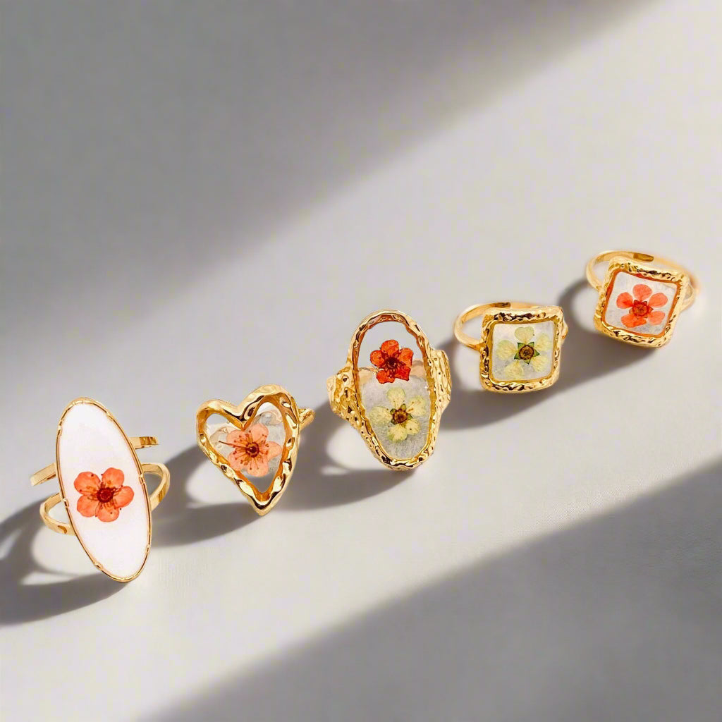 Golden Geometry Floral Ring with real False Spiraea in resin and 18K gold-plated stainless steel. Adjustable, hypoallergenic, and uniquely nature-inspired.