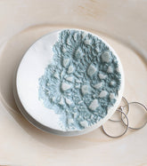 Handmade polymer clay dish with a green lace impression. Perfect as a jewelry or ring holder. Durable, decorative, and one-of-a-kind. Not food safe.