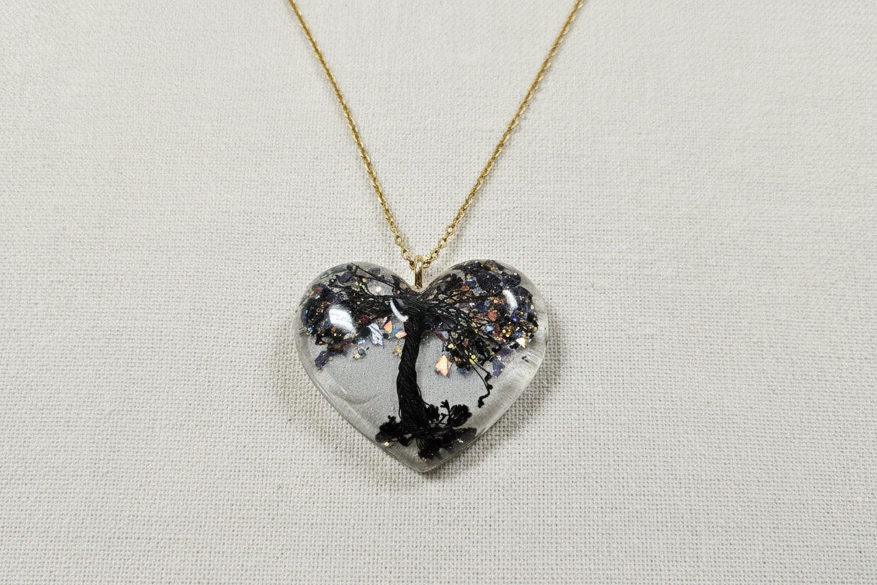 Handcrafted Tree of Life resin heart necklace on chain, symbolizing growth, connection, and balance. One-of-a-kind wearable art with soulful, nature-inspired design.