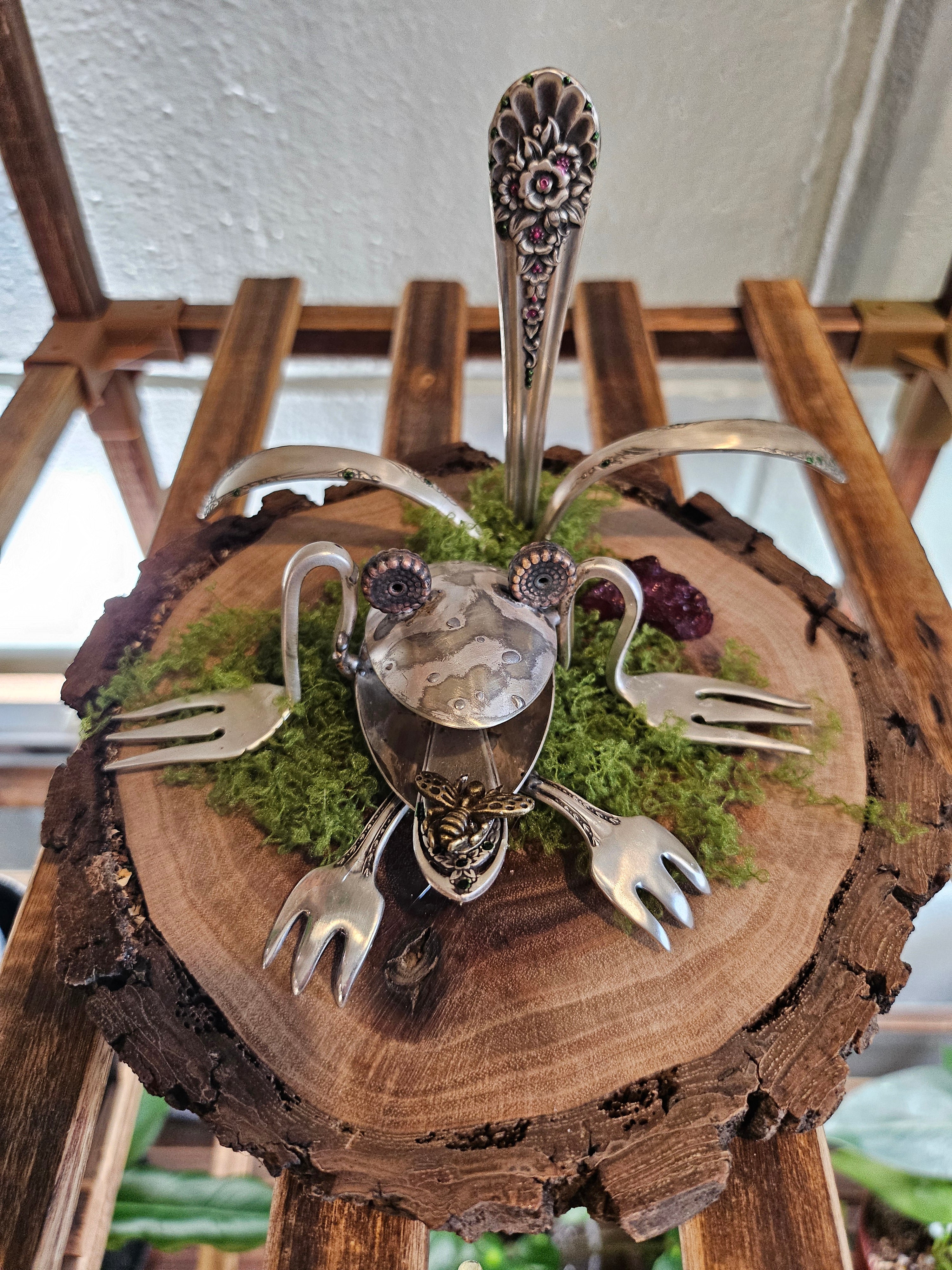 Handcrafted frog sculpture from vintage silverware, set on walnut wood with moss and crystals. A whimsical, one-of-a-kind piece for home or garden décor.