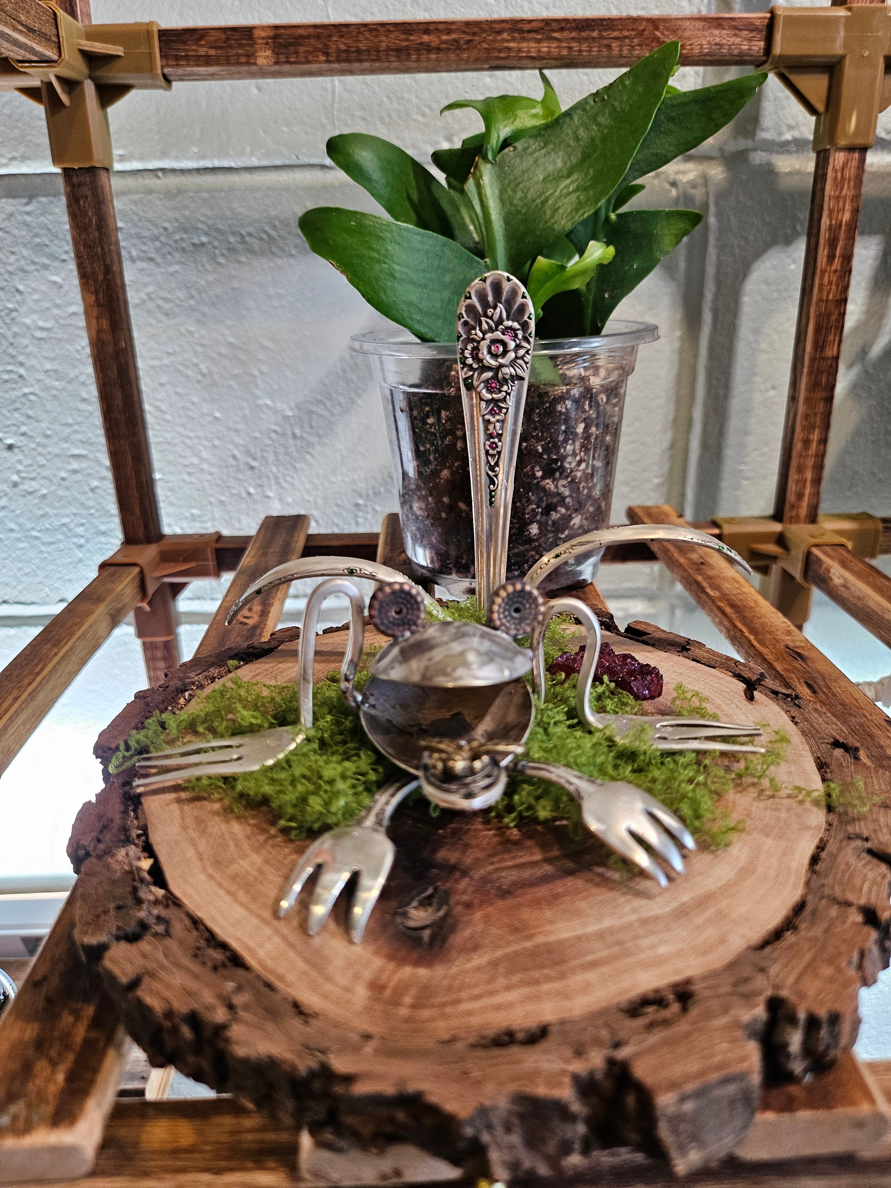Handcrafted frog sculpture from vintage silverware, set on walnut wood with moss and crystals. A whimsical, one-of-a-kind piece for home or garden décor.
