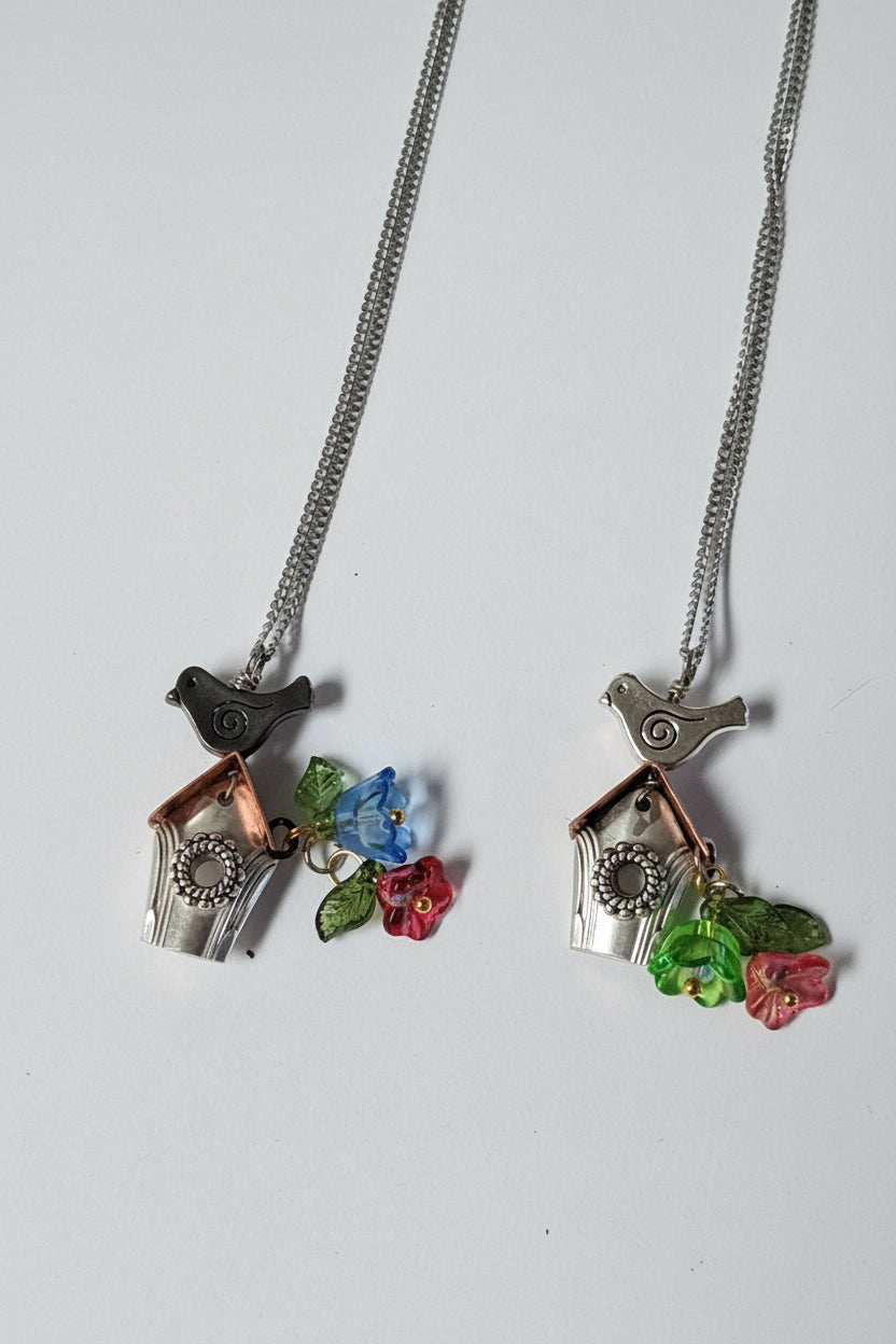 Handcrafted small birdhouse necklace made from reclaimed vintage silverware. Whimsical, cottagecore, eco-friendly jewelry perfect for nature lovers and unique gift giving.