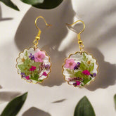 Handmade drop earrings with real pressed flowers in resin and stainless steel hooks. Each 26x43mm pair is unique, lightweight, and nature inspired.