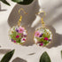 Handmade drop earrings with real pressed flowers in resin and stainless steel hooks. Each 26x43mm pair is unique, lightweight, and nature inspired.