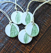 Handmade polymer clay ornaments with real leaf impressions and hand-painted detail. Unique, nature-inspired décor for trees, gifts, or year-round charm.