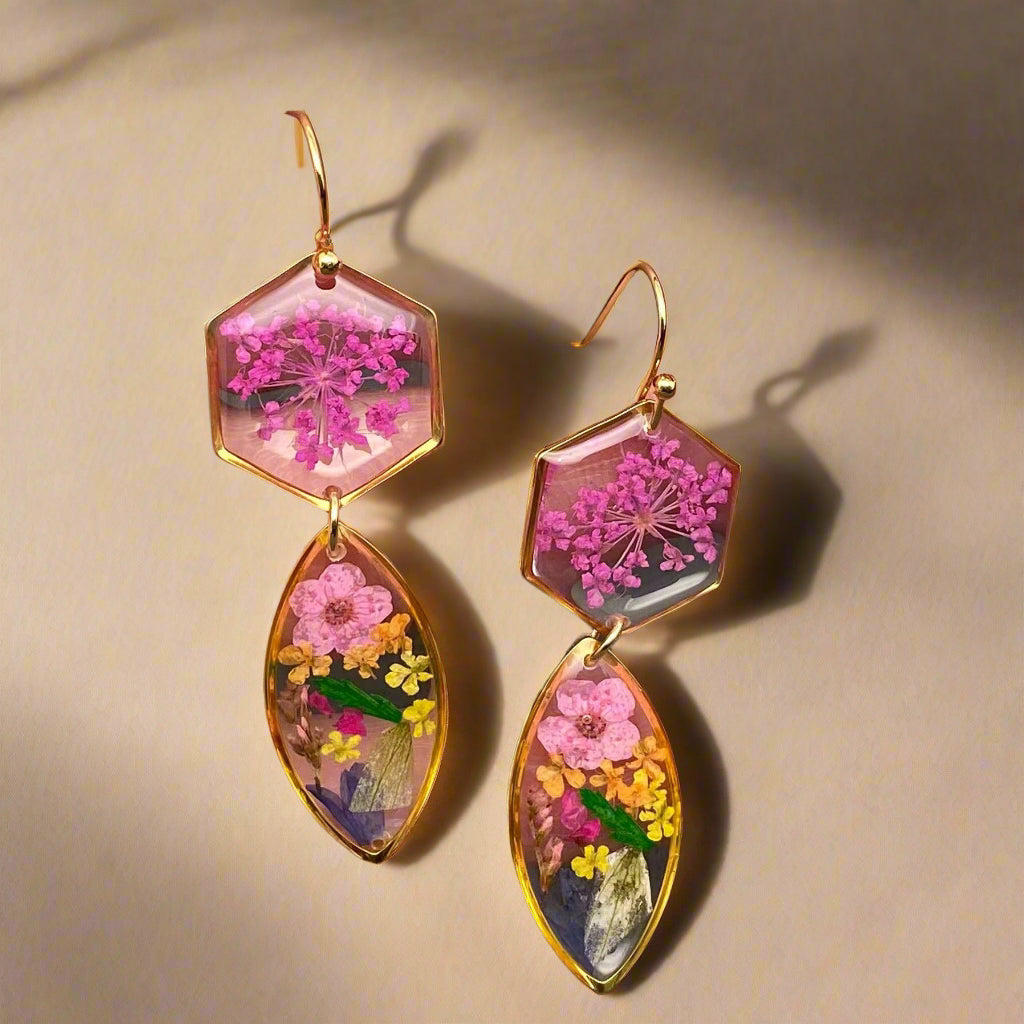 Handmade drop earrings with real pressed flowers in resin and 18K gold-plated stainless steel. Each 52mm pair is lightweight, elegant, and nature-inspired