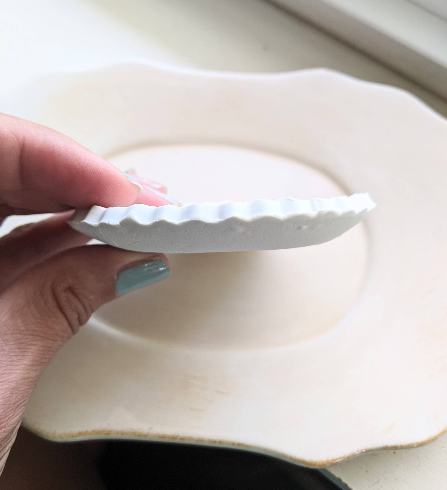Handmade white polymer clay dish with a botanical impression. Perfect for holding rings, earrings, or small treasures. Unique, durable, and decorative.