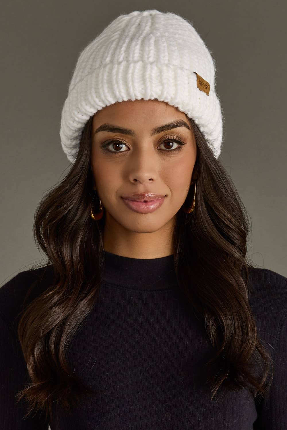 White chunky knit cuffed beanie with cozy fleece lining. Made from 100% acrylic, this classic winter hat adds warmth and timeless style to chilly days.