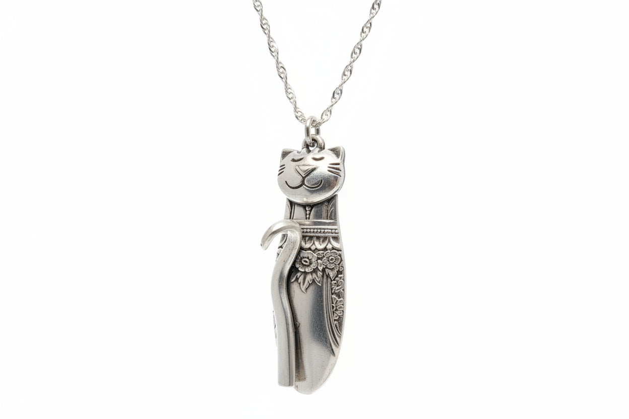 Handmade silver cat pendant necklaces from vintage silverware. Elegant, whimsical, and adjustable on a satin cord. Sustainably crafted and one-of-a-kind.
